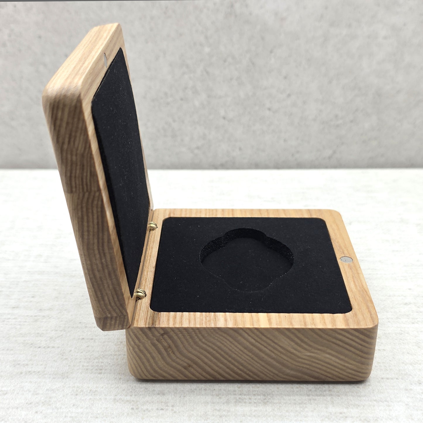 Side view of open natural ash wood challenge coin box with elegant black velvet lining, magnetic closure wooden case.
