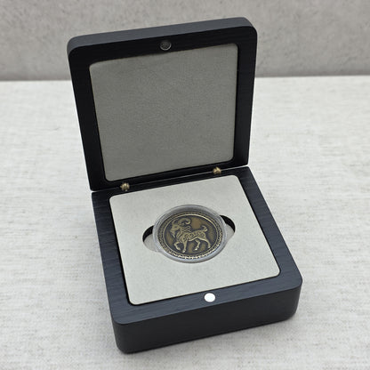 Handcrafted black ash wood gift box showing custom commemorative coin inside protective capsule on light gray velvet foam insert.
