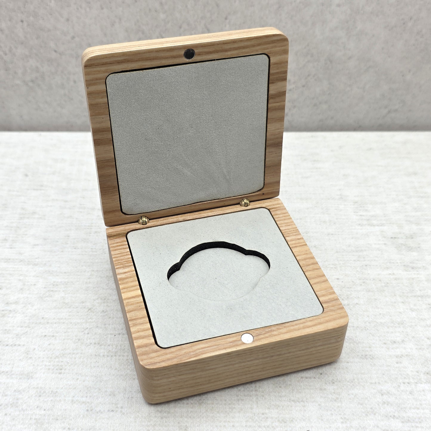 Open natural ash wood coin box with soft light gray velvet insert, elegant presentation case for military coins and medallions.