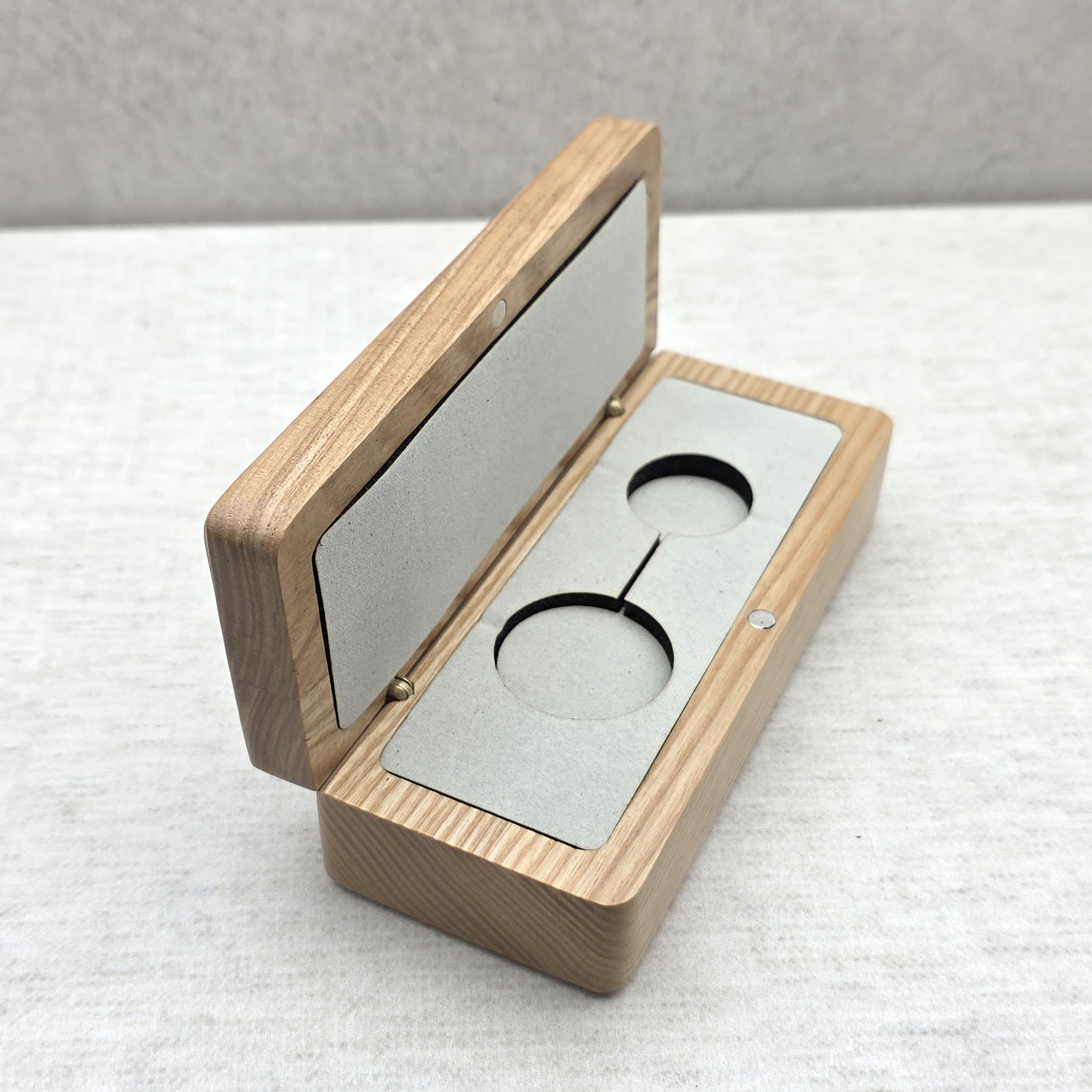 Open natural ash wood gift case featuring light gray velvet insert with double cutout for pendant necklace or keychain