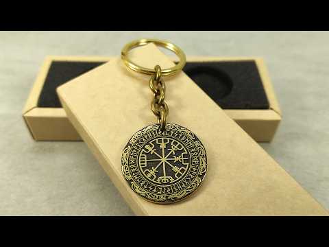Video showcase of a personalized brass Runic Compass keychain, highlighting the metallic gold-tone texture and high-contrast professional patina.