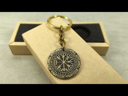 Video showcase of a personalized brass Runic Compass keychain, highlighting the metallic gold-tone texture and high-contrast professional patina.